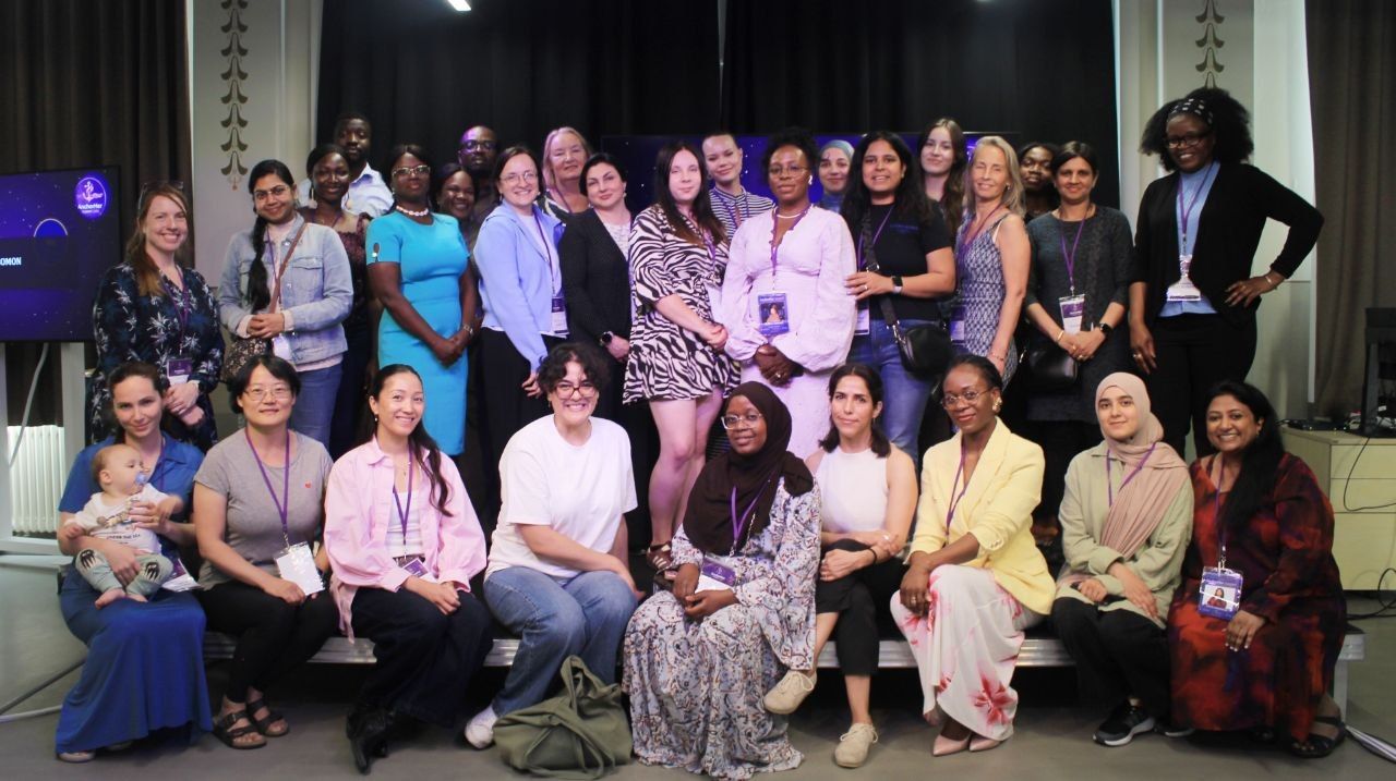 Members and friends gathered together on stage after an Anchor Her event